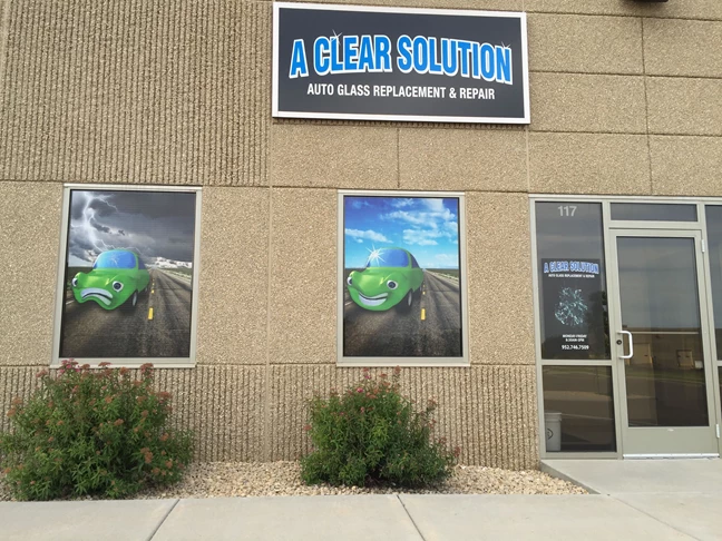 Storefront sign and window graphics using perforated vinyl